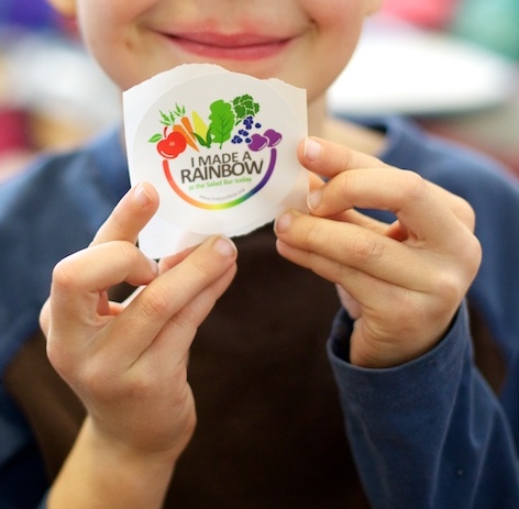 A kid holding a sticker